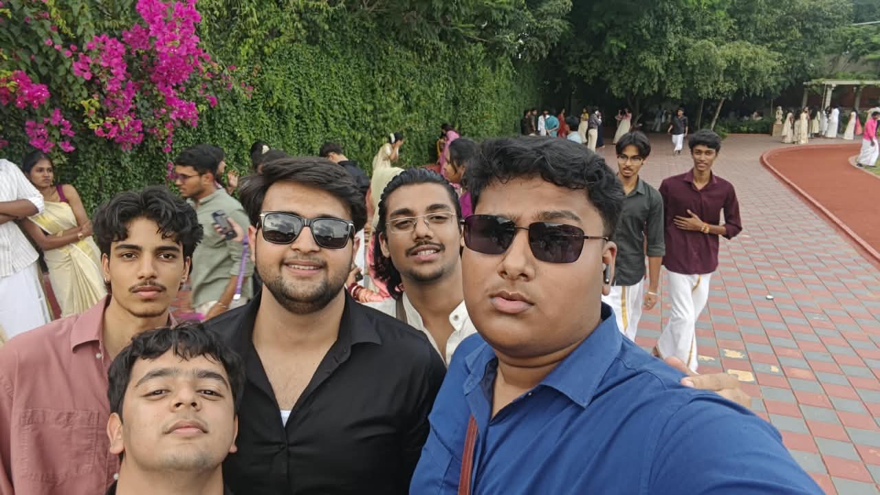 Five friends squeezed into a selfie on campus